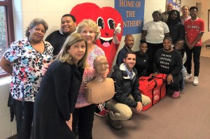 Betty and Bruce Howard Jr. present faculty, staff, and students at Charles City High School with an American Heart Association CPR in schools training kit to assist with providing tips and instructions of lifesaving skills.