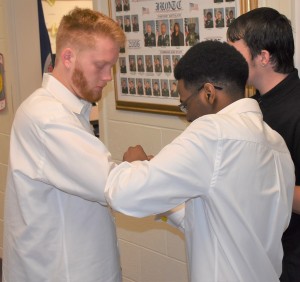 Jamon Brown (right) helps Steven Trull Jr. (left) with his cufflinks in preparation for the ceremony.