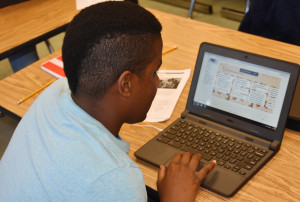 New Kent Middle School Student DaJour Weeden uses his computer to respond to dialogue as part of the Global Read Aloud program.