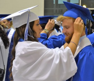 Harley Gostel (left) makes sure classmate Joshua Squares (right) is at the peak of perfection prior to commencement ceremonies.