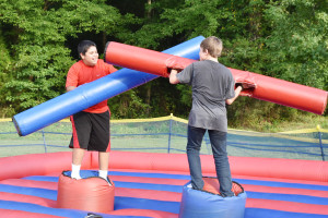 Kids battle it out on an inflatable jousting pit as one of the activities provided at Charles City’s National Night Out event.