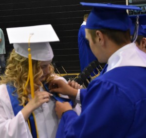 Christine Best (left) gets the final touchup to her gown with an assist from Brendan Day (right).