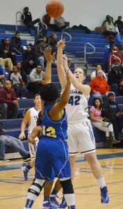 Lady Trojan Becky Anderson launches a shot over Lady Panther Jessica Hill that would eventually bank off the backboard and through the net.Andre' Jones photo