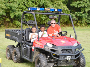 Below, Dep. Scott Greene gives two young deputies in training a ride in the department’s off-road terrain vehicle.