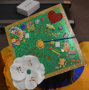 Dashia Smith’s mortarboard expresses the motto of “Behold the Green and Gold,” a sign of her future studies at Norfolk State University.
