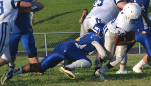 New Kent fullback Kyle Coles (30) powers through the arm tackle attempt by Charles City’s DeAndre’ Gardner.