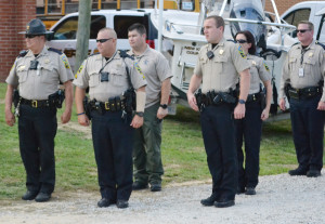 Several deputies of the sheriff’s office stand at attention as the national anthem is sung to begin the event.