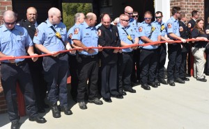 New Kent Firefighters and EMTs take part in the hose uncoupling ceremony that signifies the station's "ribbon cutting."