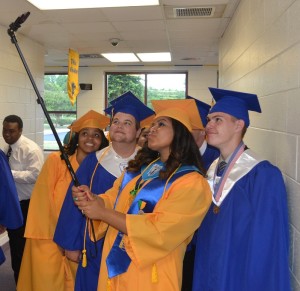 Meanwhile class salutatorian Vanessa Adkins, takes the trend one step further, pulling out a 'selfie stick' and snapping her own group photo. 