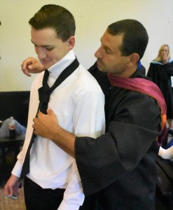 Athletic Director John Spiak (right) assists Colby Brooks with his tie to make sure he looks professional on his big day.