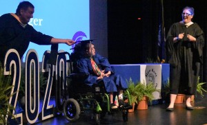It’s happiness and smiles as Kayla Lynn Clayberger receives an assist with her hat from high school principal Chris Valdrighi as she poses with her diploma for a memorable graduation photo.