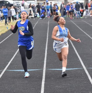 Charles City's Alexis Williams (left) battles New Kent's Yaz'mine Brown (right) in the opening heat of the girls' 100-meter dash.
