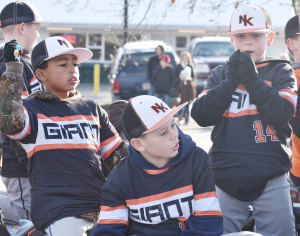 Members of the New Kent Giants warm up their pitching arms by tossing candy out for all to enjoy.