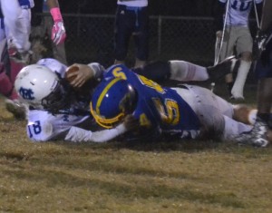 Charles City's Jayron Jones (54) plants Middlesex signal-caller Cameron Wells into the ground during a fourth quarter run.