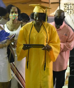 Aysia Wallace looks down at her diploma as she comes to grips that she is now a high school graduate.