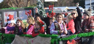 Girl Scout Troop 179 give well wishes and candy along the parade route.
