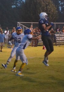 Trojan wideout Slater Gammon (16) hauls in a pass in front of Charles City’s Kyle Jones to account for the final touchdown of the contest.