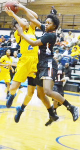 Deborah Smith is fouled while driving to the basket by Campbell’s Jessica Pone.