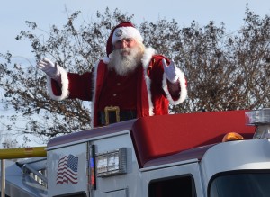 Santa Claus waves to all the good girls and boys from atop of a fire truck at the conclusion of the parade.
