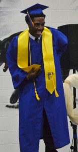 Antonio Harris takes a bow after his name is called to receive his diploma.