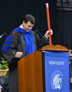 Superintendent of schools David Myers pulls out a giant red pencil, drawing laughter in reference to the traditional "pencil story" told at many New Kent High graduations.