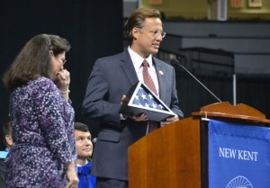 Retiree Patti Gulick (left) is moved to tears as United States Representative David Brat presents her with a flag that has been flown over the U.S. Capitol in recognition of her 37 years of teaching at New Kent High School.