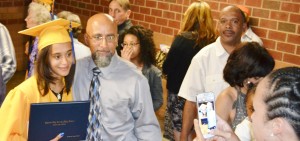 After the ceremony, Marshayla Bradby proudly displays her diploma for a family photo opportunity.