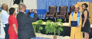 Jessica Hill enjoys her moment in the sun as family members snap pictures of the momentous occasion.