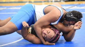 New Kent's Jamar Christian places his weight on Petersburg's Jordan Alston on his way to a pinfall victory.