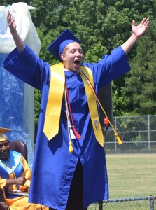 Noah Ragland pumps up the crowd and embraces the cheers as he walks across the stage to receive his diploma.