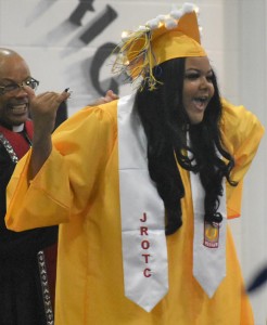Vashelle Smith can’t help but to express her delight on her way to receiving her diploma.