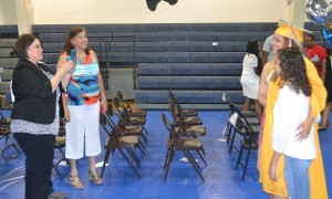 Inside the gymnasium, Raven Christian poses for one of her many photos as she is congratulated on her accomplishment.