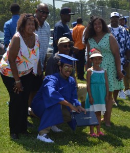 After the ceremony, Chris Copeland (center) strikes a pose with family members to archive his achievement.  