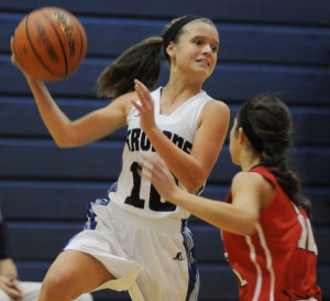 Lady Trojan Payton Slater leaps to fire a pass to a teammate over the head of Grafton defender Kierson Tavares.