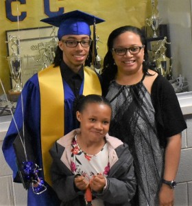 Keimon Cotman receives a snapshot photo with his family to commemorate his graduation day.