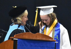 Interim superintendent of schools Dr. Carol Fenn (left) bestows the valedictorian medal around the neck of Taylor Yates.