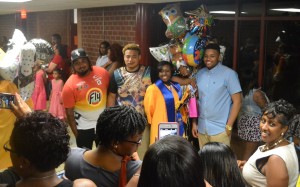 Q'Nique Cotman poses with cousins as family members prepare for the photo opportunity.