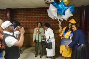 Tamea Delaney is all smiles as she has her hands full with balloons and love during a picture with her family.