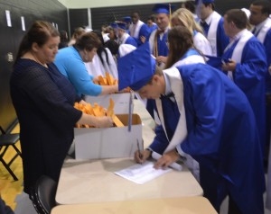 Kyle Claytor provides his signature to officially receive his high school diploma.