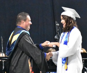 Tahlia Wynn smiles in delight as she shakes the hand of New Kent High principal Chris Valdrighi and receives her diploma.