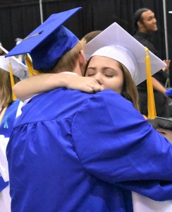 An emotional brace after the ceremony takes place between Ciara Young (back) and Logan Deters (front) after they realize their transition into alumni of the school.