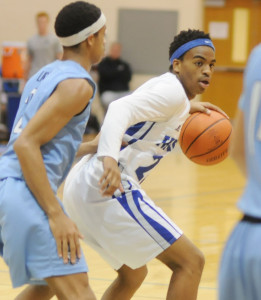 New Kent's Patrick Minor looks to pass to a teammate while closely guarded by Warhill's Dearius Brooks.