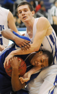 Charles City's Jaquane Wyatt tries to protect the ball and escape from New Kent's Ryan Lugg.