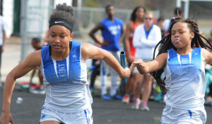 Lady Trojan Adrienne Goodlet takes the baton from Samiyah Harris for the final leg of the 4x100 meter relay. New Kent finished fifth.