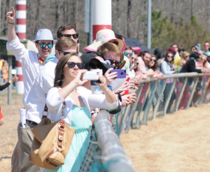 Spectators along the rail cheer for their favorite mount and photograph the action. Richmond Ski Club won the tailgating competition.