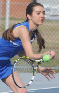 Lady Trojan Maddie Miles charges toward the net to return a shot in number five singles.