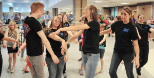 A group of students in zombie makeup from all four county schools dance as a "flash mob " in the hallway, much to the delight of guests.