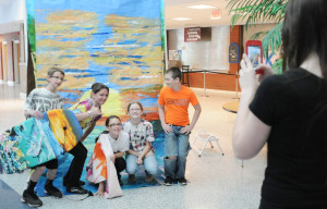 Families also took advantage of a "free photo booth" where they posed before a background of their choice painted by art students.