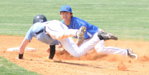 New Kent shortstop Mason Downer waits to tag out Warhill’s diving Luke Patterson on a sixth inning steal attempt.