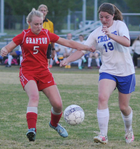 New Kent's Jennifer Critz (19) engages in a bit of a shoving match  with Grafton's Olivia Lilygren for control of the ball.